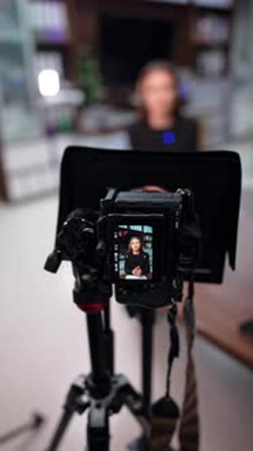 Female influencer on a display of professional camera.