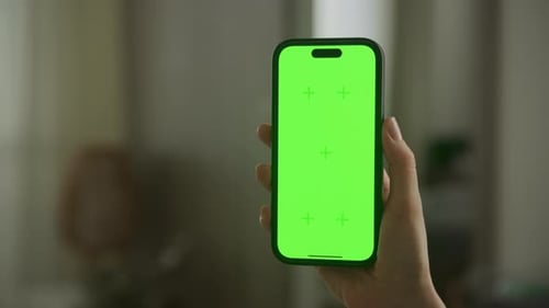 Hand Holding Smartphone with Green Screen