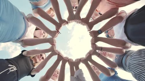 Group of Students is Joining Hands Forming a Circle Outdoors in the Summer Low Angle View From Below