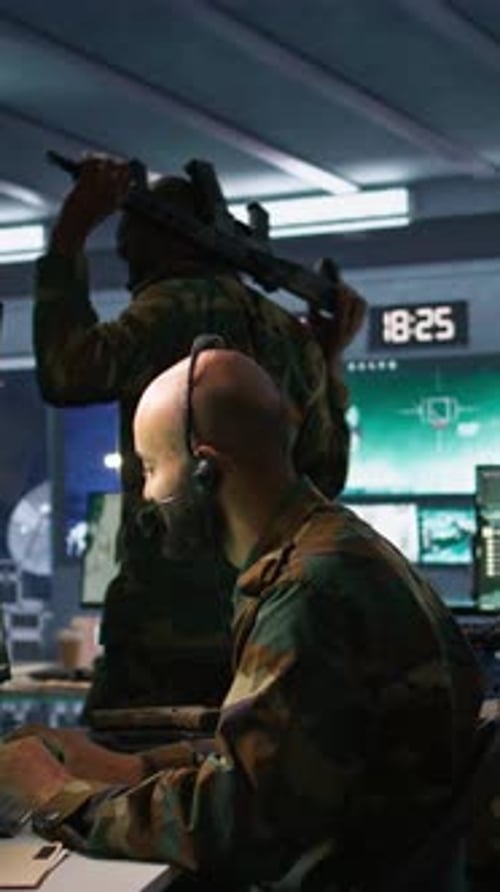 Soldier at Computer in Dark Military Control Room
