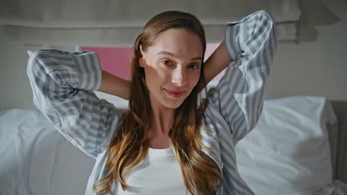 Young Woman Wakes Up and Stretches