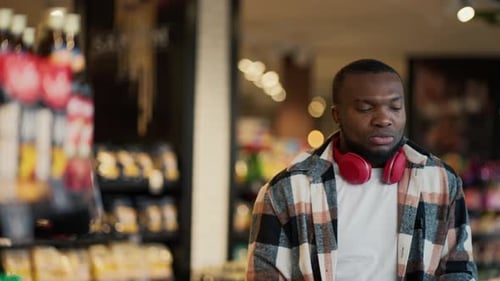 Young Man Dancing to Music in Grocery Store