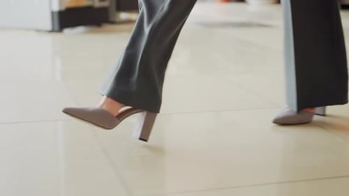 Closeup of Businesswoman Walking in Heels Across Polished Office Floor