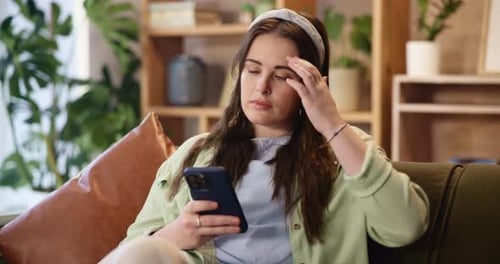 Young Woman Relaxing at Home Using Phone