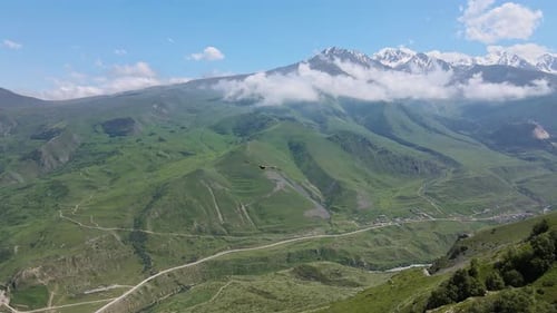 Aerial View of a Bird of Prey Flying Along a Rocky Mountain in a Gorge