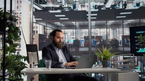 Man Working at Desk in Bright Modern Office