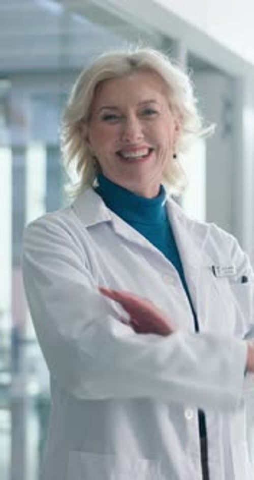 Crossed arms, hospital and face of mature woman for medical service, confidence