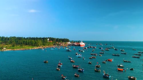 Vibrant Fishing Harbor Teeming with Colorful Vessels Anchored Against Azure Sky Capturing Maritime