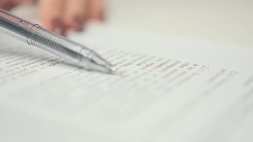 Close-up: woman lawyer office worker proofreading a contract before signing