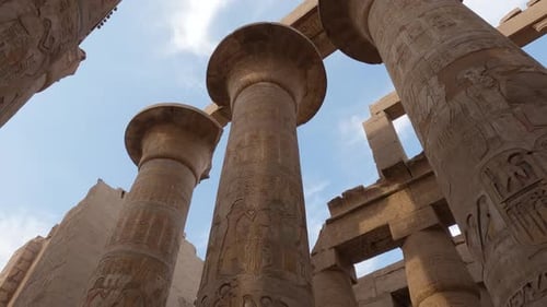 Panning shot revealing pillars of the luxor karnak temple in Egypt in broad daylight