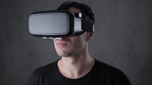 Man Wearing VR Headset Interacting with Technology