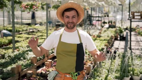 Happy Gardener Smiling in a Bright Greenhouse