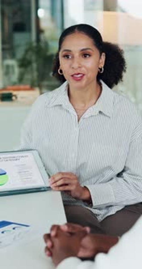 Businesswoman Explains Data on Tablet During Office Meeting