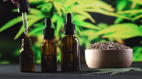 Hand Pressure Pipette CBD Oil Falls Into Bottle of Legalized Cannabis ...