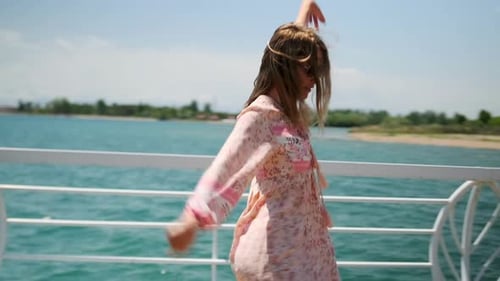 Woman Dancing in Floral Dress on Sunny Pier