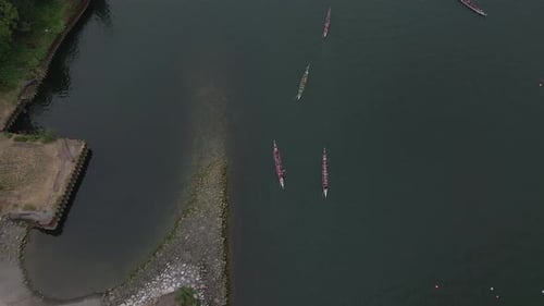 Dragon Boat Teams Rowing in River Aerial View