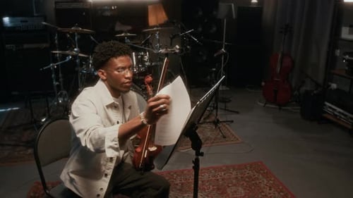 Young Adult Plays Violin in Music Studio