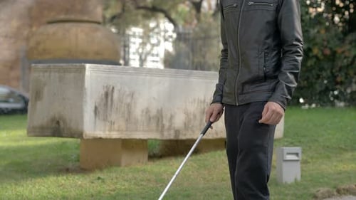 blind man walking alone with stick in the park.Handicap, autonomy