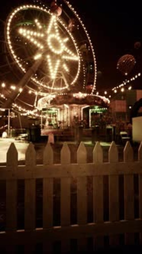 Illuminated Merry Go Round in Abandoned Park at Night