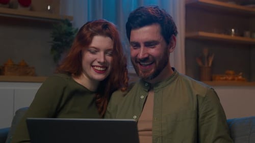 Affectionate Couple Watching Laptop at Home