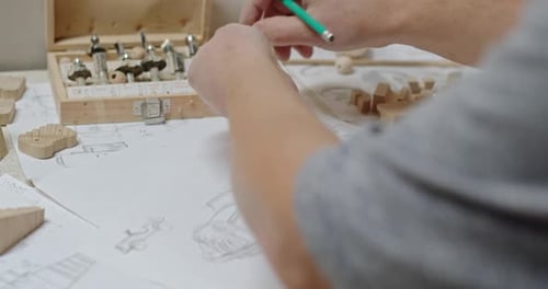 Hands Crafting Wooden Toys with Designs