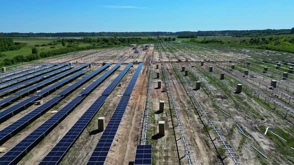 PV panels being installed on newly developed solar farm, aerial riser ...