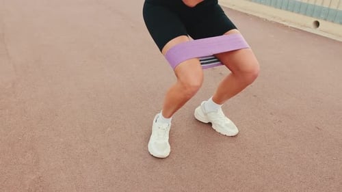 Woman Working Out with Resistance Band