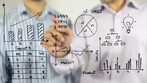 Men Discussing Business Data Behind Glass Board