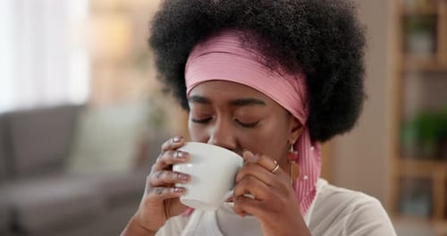 Smiling Woman Drinking Hot Beverage at Home