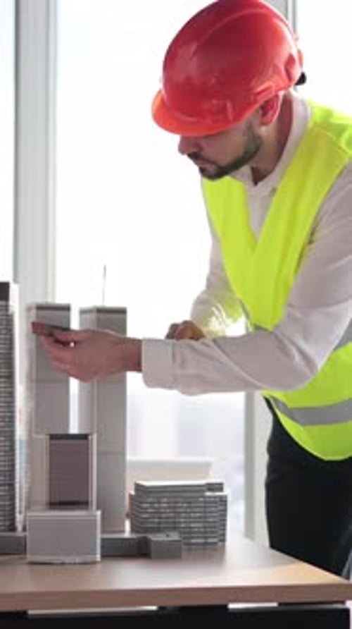 Architect Measuring Building Model