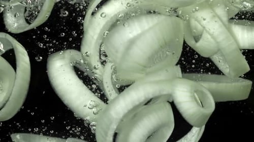 Slices of Onion in Water with Bubbles