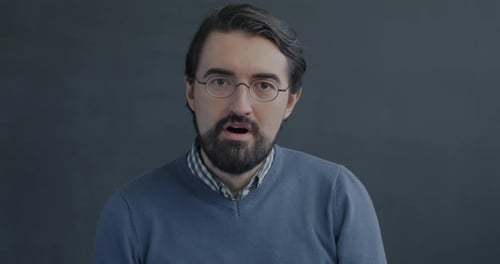 Man Talking and Smiling with Surprise