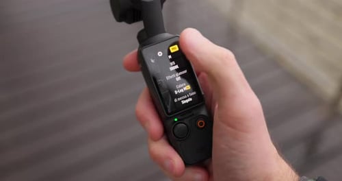 Hand Adjusting Settings on Handheld Gimbal Stabilizer