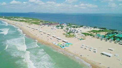 Aerial Over the Long Sandy Spit with a Beach and Azure Water on a Sunny Summer Day Waves Crashing to