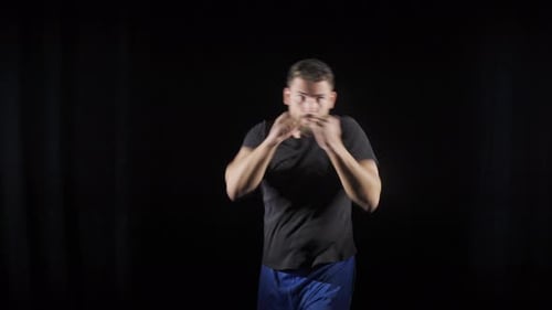 Man Boxing in Front of Black Backdrop