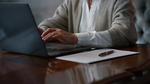 Woman's Hands Typing on Laptop at Desk