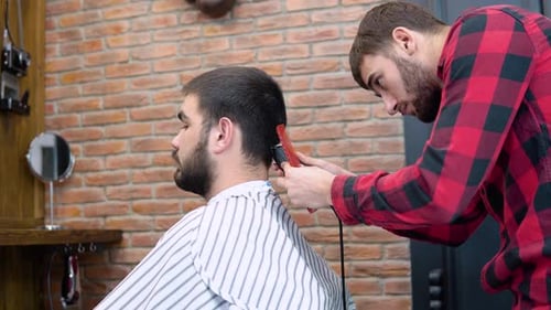 Barber Giving Haircut in Trendy Urban Barbershop