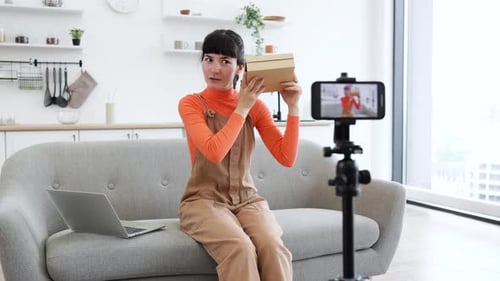 Caucasian Female Blogger Unboxing Smartphone on Live Video Stream