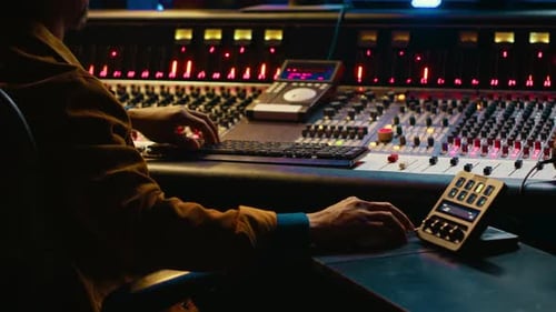 African American Sound Designer Working with Editing Software to Produce Tracks