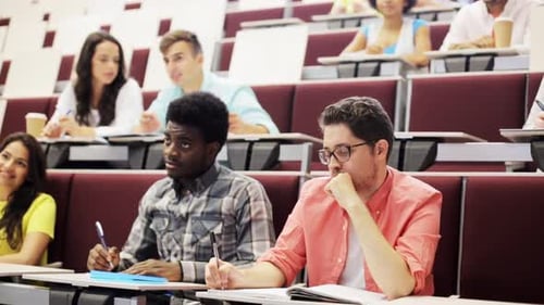 Group of International Students with Notebooks Sitting in Lecture Hall and Talking African