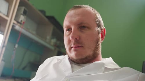 Adult Man in Lab Coat in Workplace