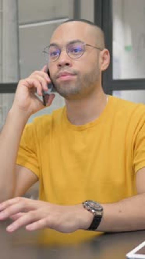 Hispanic Man Talking on phone in Office, vertical video