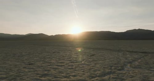 a large flat area with mountains in the background