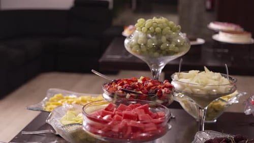 Elegant fruit buffet with assorted fresh fruit in glass bowls