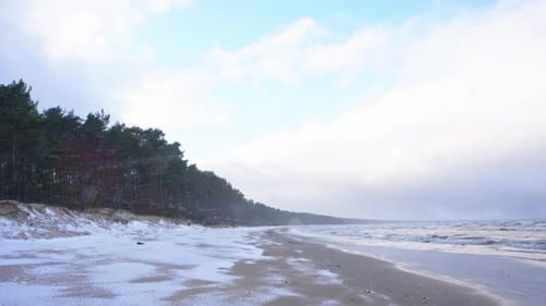 Scenic Winter Storm Beach with Snow and Tranquil Atmosphere