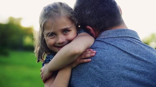 Father with a Small Daughter Having Fun in Spring Nature