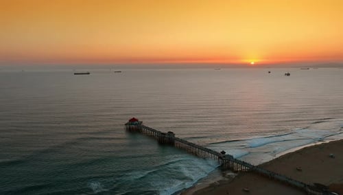 Sun setting above the waterscape of the Pacific Ocean.
