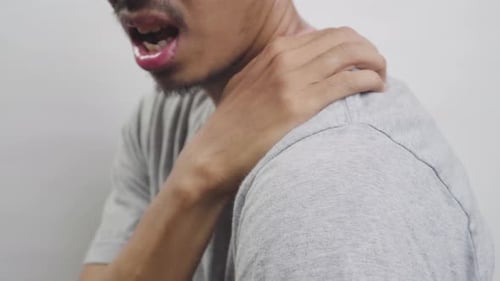 Man Holding His Sore Neck and Shoulder