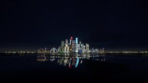 Illuminated Modern City Skyline Reflected on Water at Night