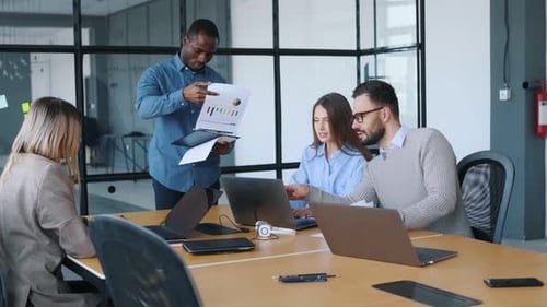 Business conception. Professional workers are in the modern office together.